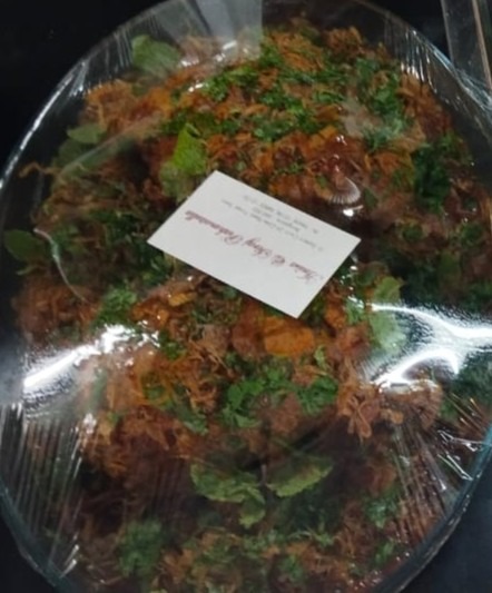 Garnished mutkuley platter packed with a name card for delivery