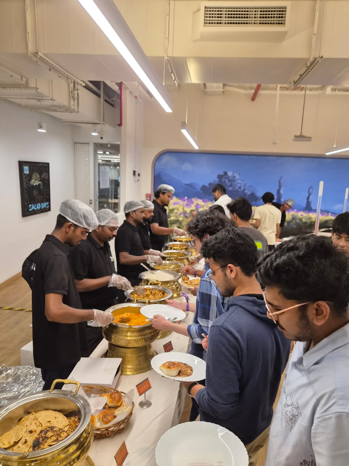 Anisa's Kitchen team serving a corporate buffet line
