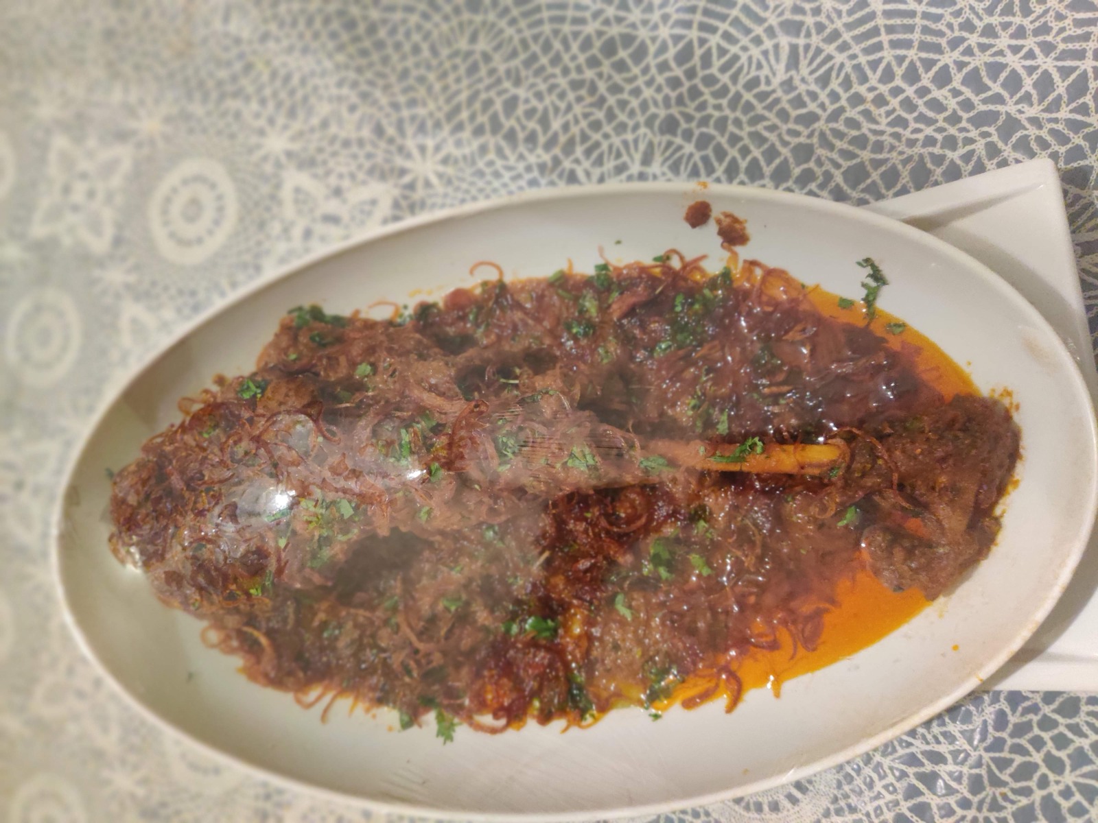 Kutchi Memon mutkuley topped with fried onions and coriander