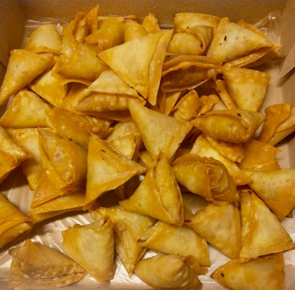 Golden hand-folded warki samosas