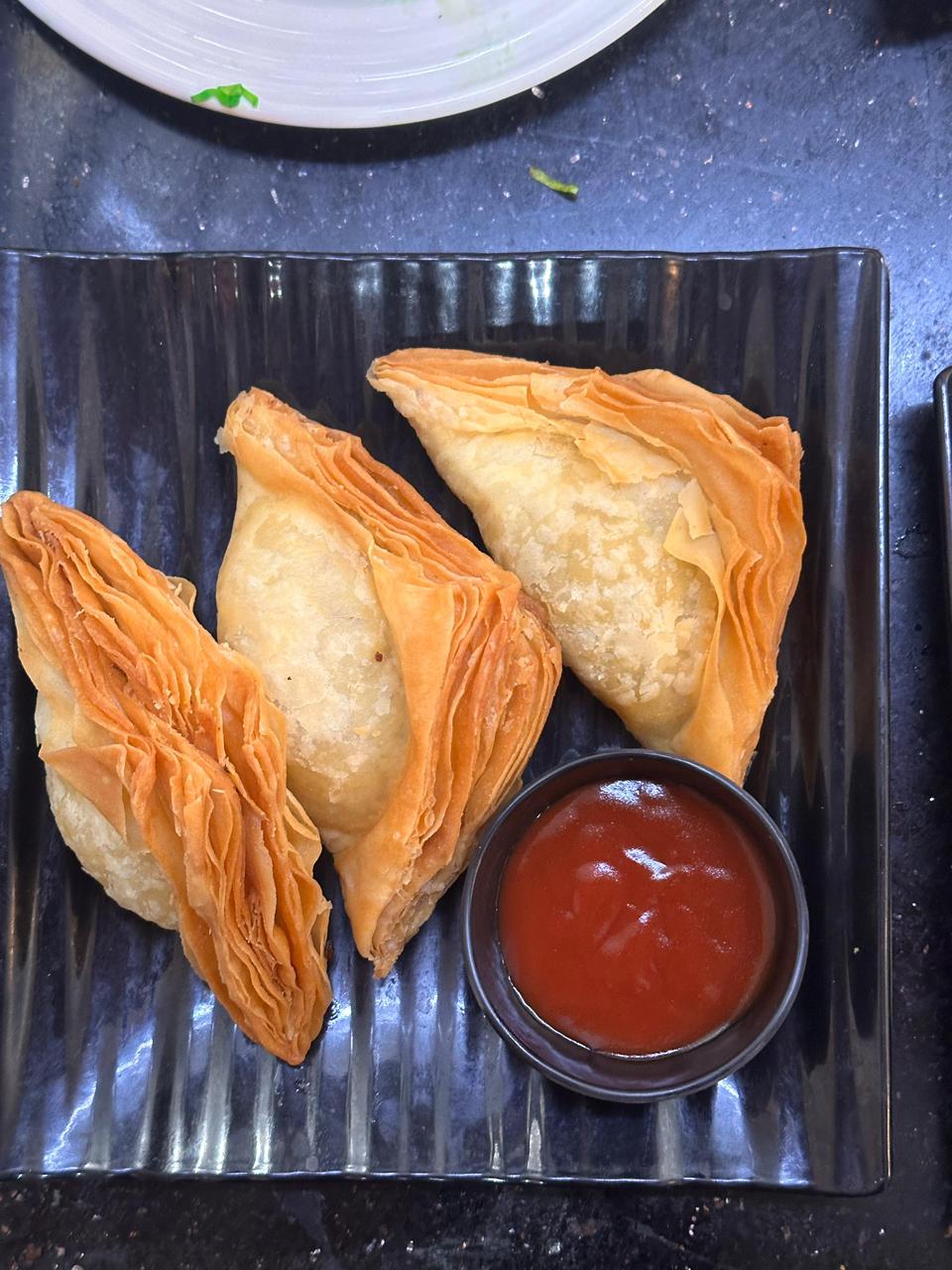 Hand-folded warki samosas with ketchup