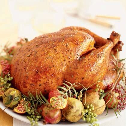 Golden herb roasted whole chicken garnished with fruit