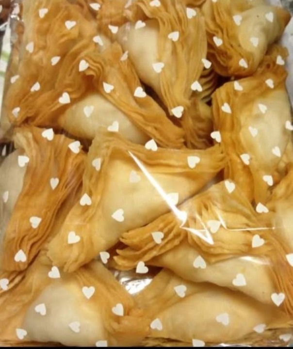 Layered warki puff samosas packed in a tray