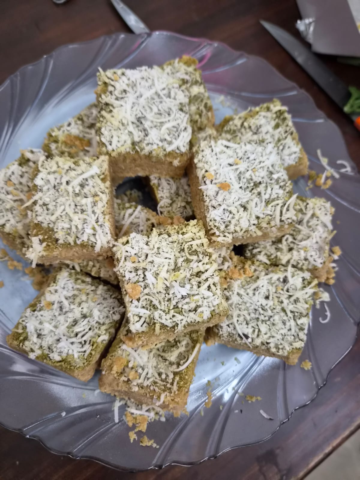 Cheese chilli toast squares topped with herbs and grated cheese