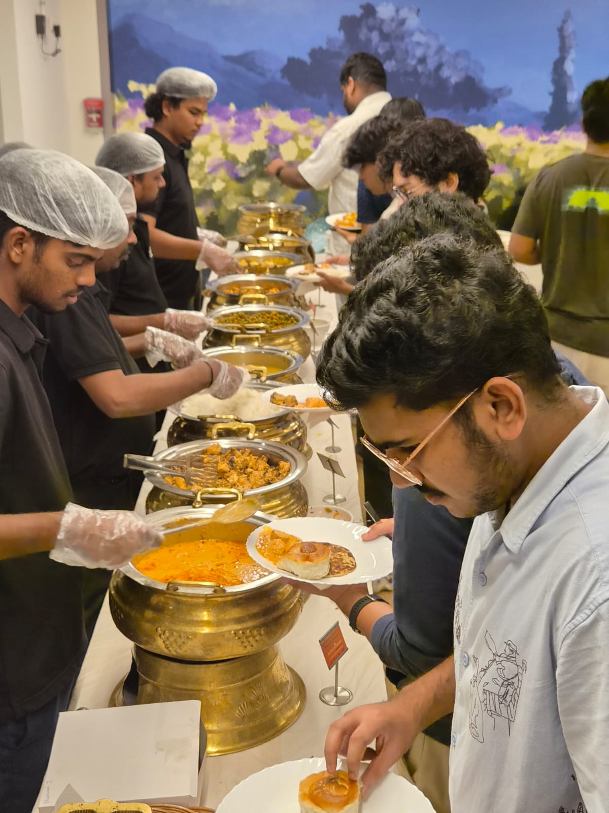 Catering team serving a live buffet line to guests