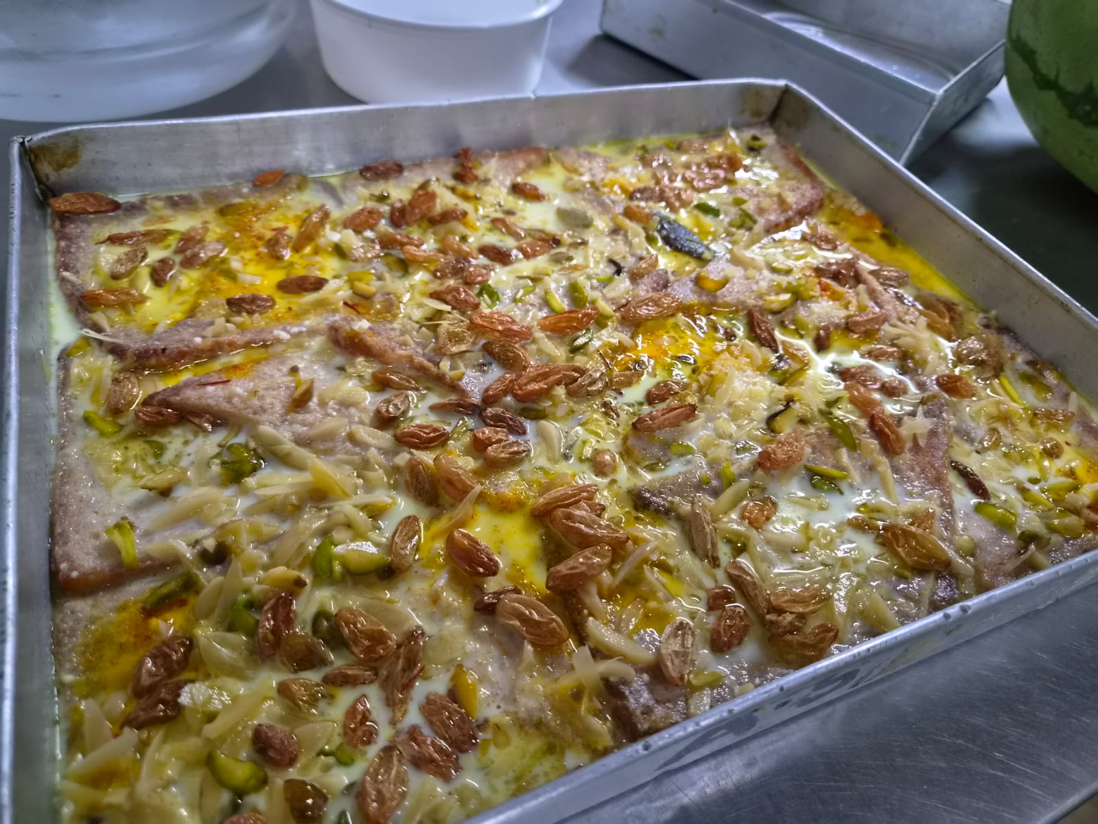Tray of shahi tukda with saffron rabdi, raisins and almond slivers