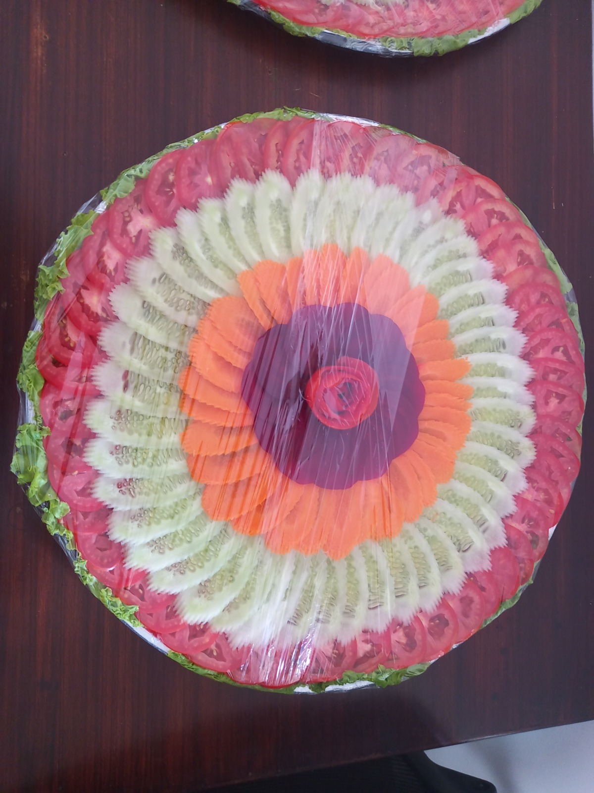 Decorative salad platter of tomato, cucumber, carrot and beetroot