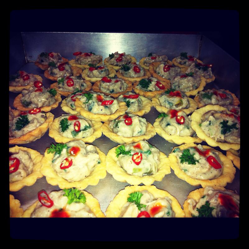 Tray of chicken canapes garnished with chilli