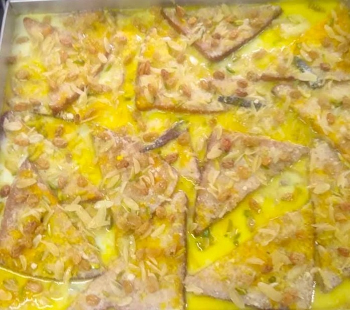 Shahi tukda with saffron rabdi, raisins and almond slivers