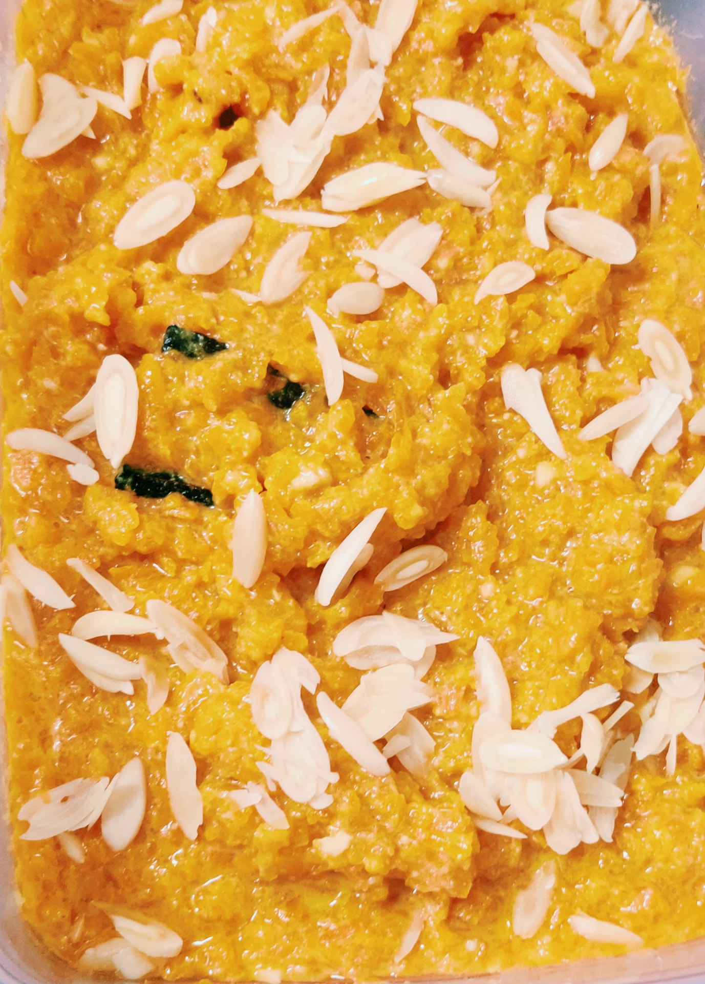 Carrot halwa topped with slivered almonds